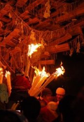 Small boy lighting a big fire